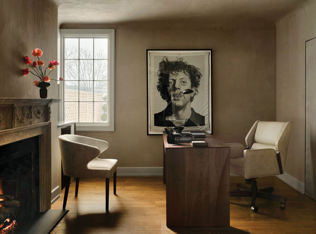 This private office is a study of sophistication. The original limestone fireplace brings heritage, while a large tapestry reproduction by Chuck Close adds artistic depth. 