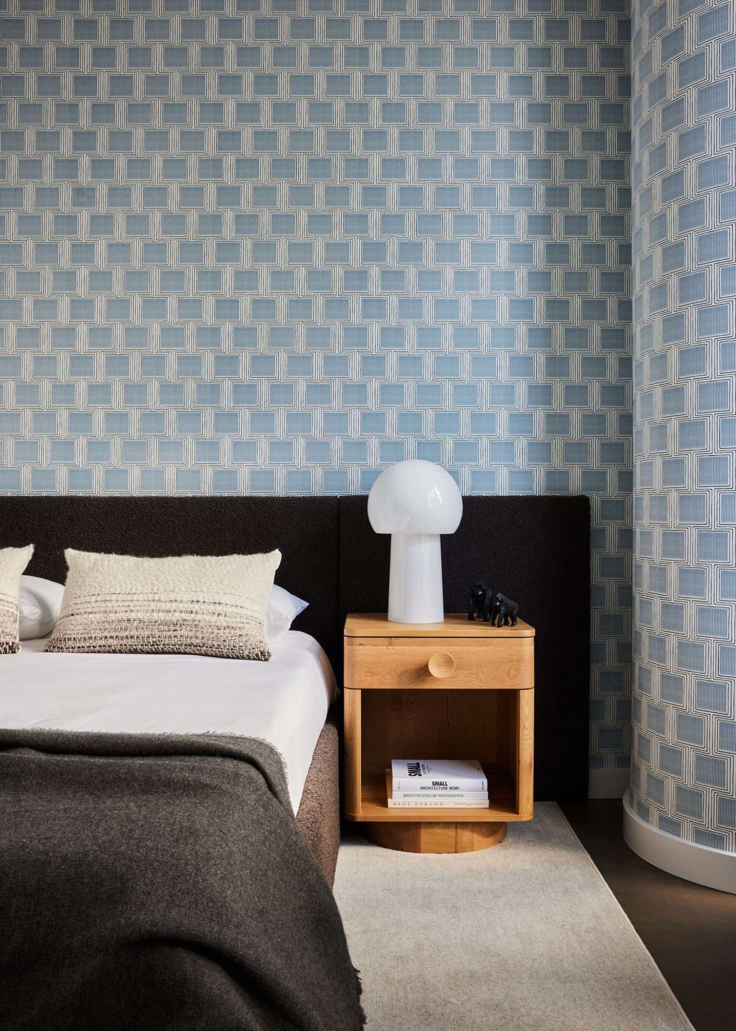 modern bedroom in neutral tones with contrasting blue and beige wallpaper