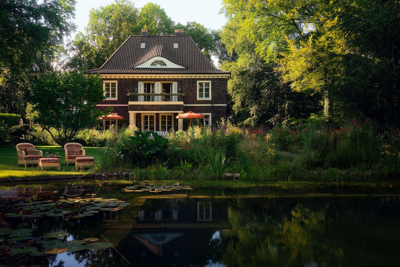 Modern Villa surrounded with garden and natural pond