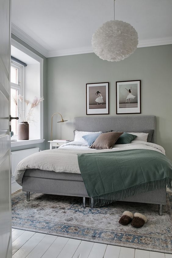 pale green bedroom with a bed