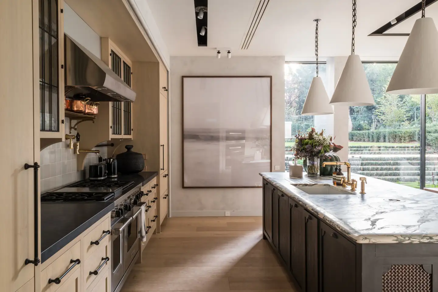 Modern kitchen in beige tones with a marble kitchen island