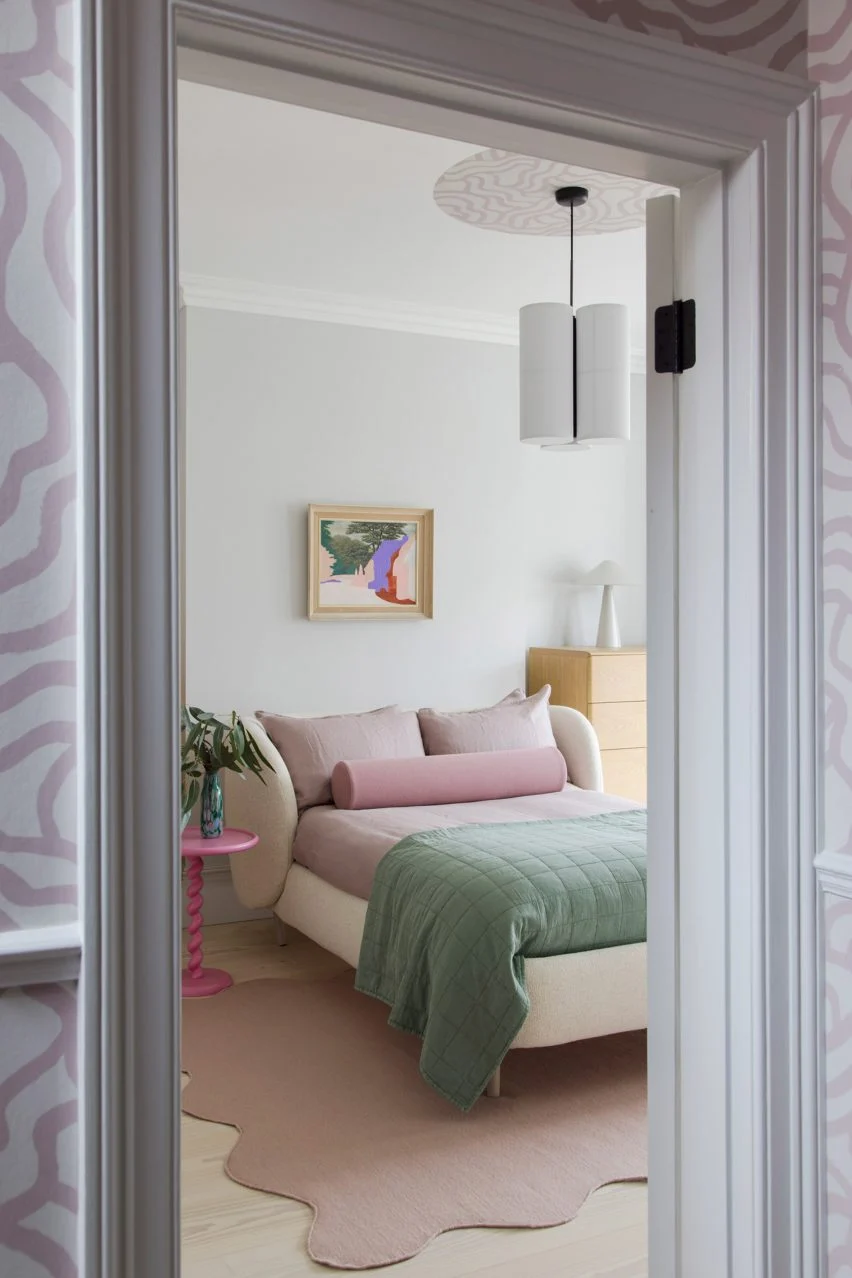 bedroom with pink pillows and pink rug