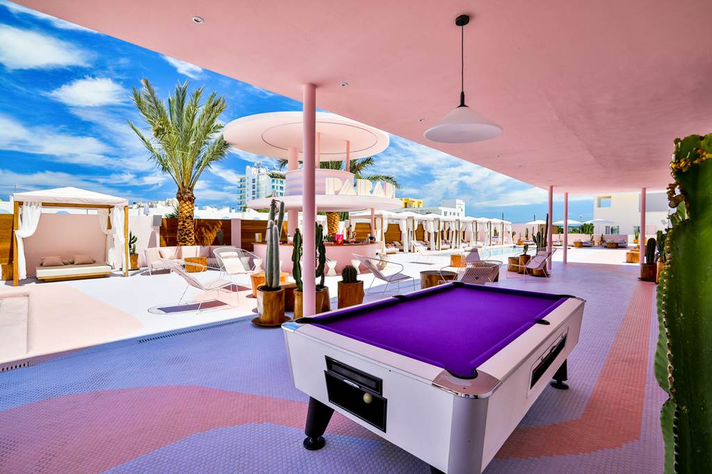 A purple pool table in the outdoor area of the hotel