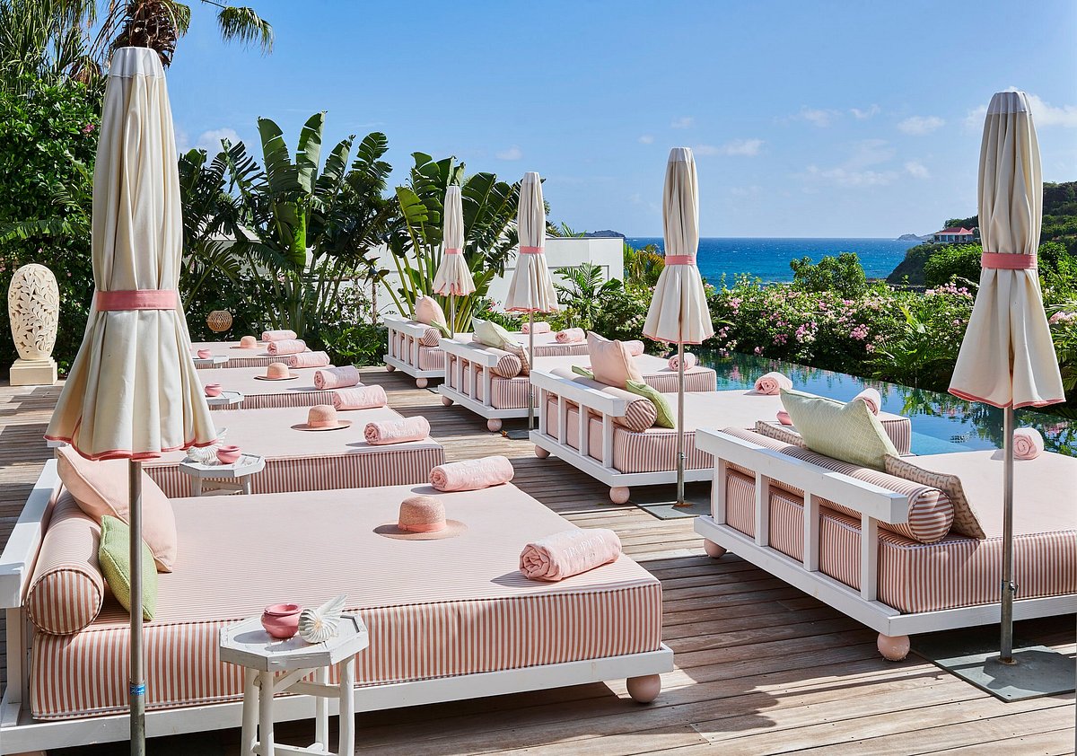 pink striped sunbeds and  matching parasols
