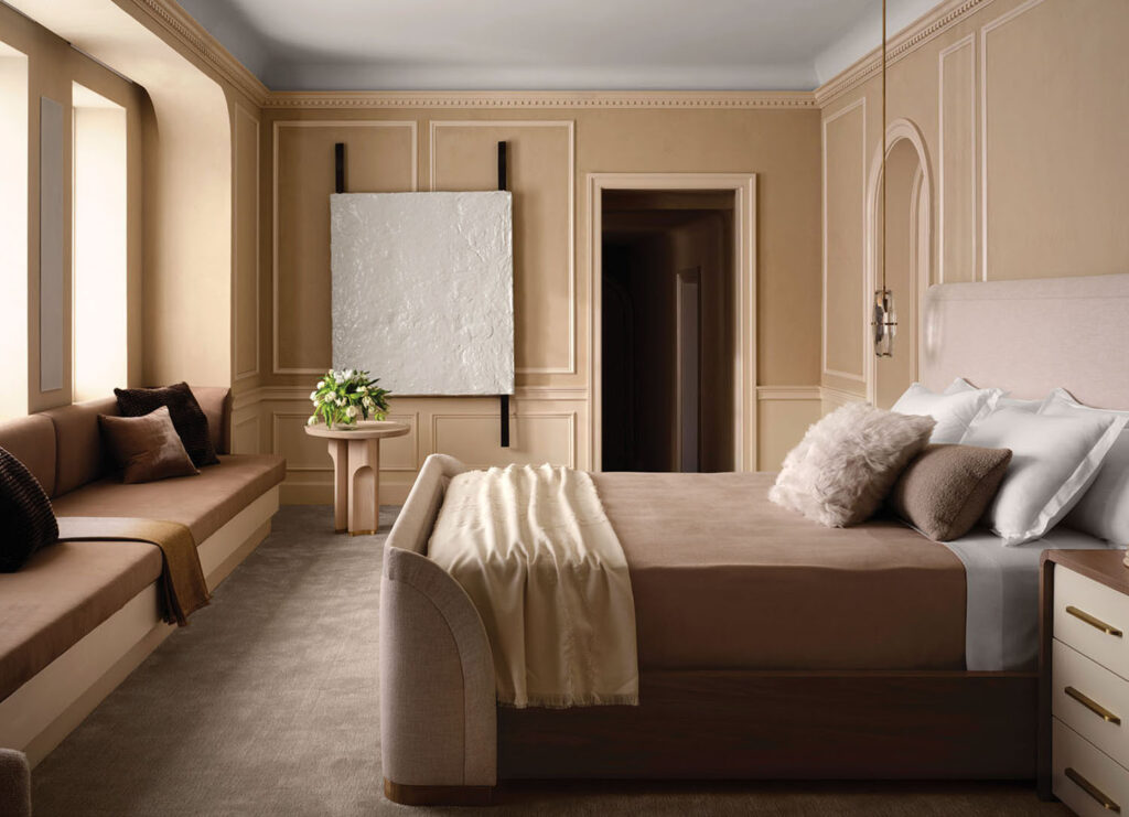  A tailored bed with plush, layered linens anchors in the room, accompanied by gold-accented nightstands for subtle luxury.