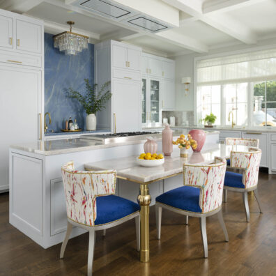 white marble kitchen with chic blue chairs