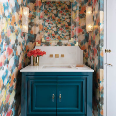 bathroom with colorful and flower print wall, with blue sink