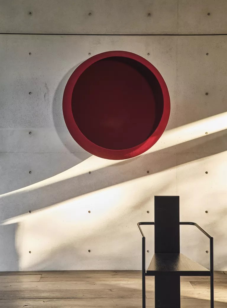 A sculpture by Anish Kapoor hangs above a chair