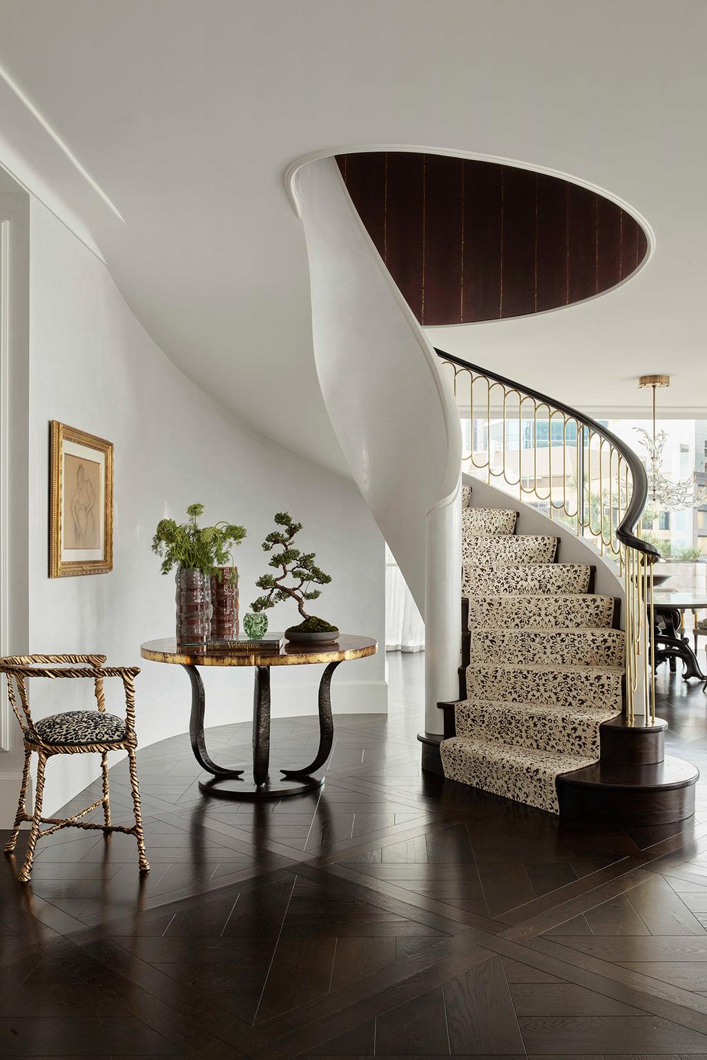 detailed gold chair upholstered in zebra print next to a staircase upholstered in animal print